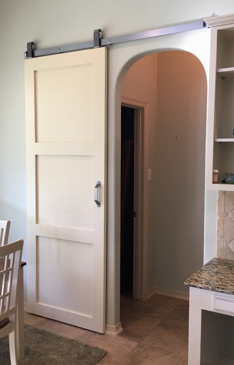 Shaker style barn door in Fort Lauderdale kitchen.